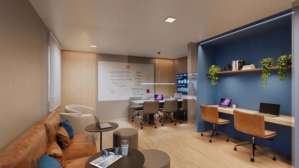 Coworking com estações de trabalho e sofá.